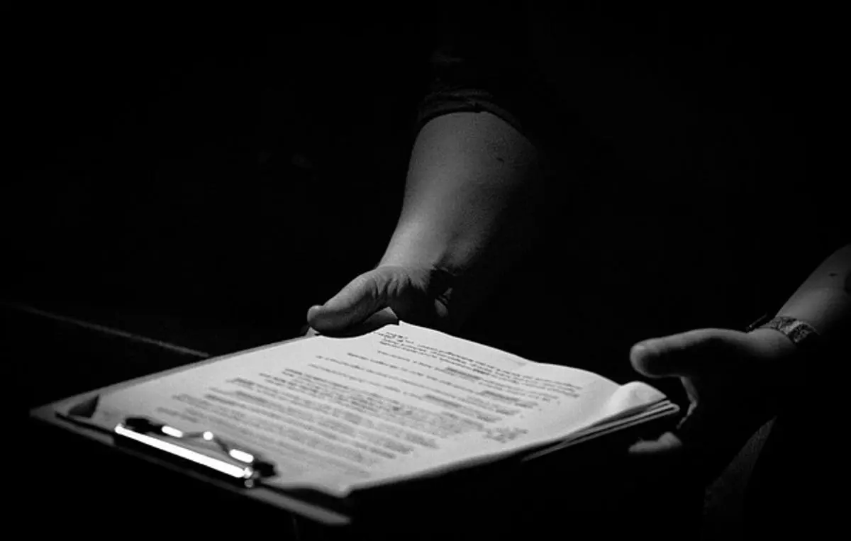 person-holding-a-clipboard-with-document