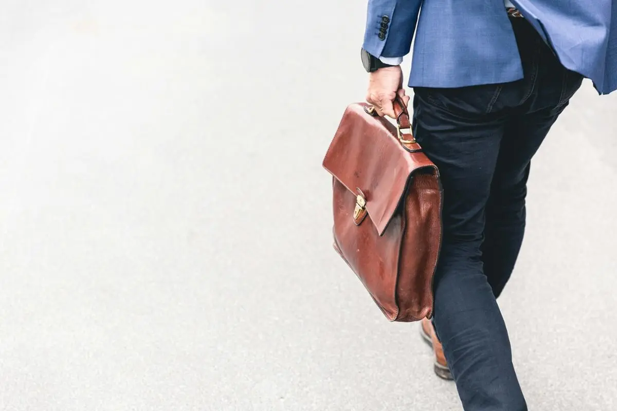 A person with a briefcase walking