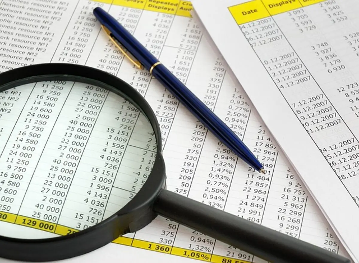 finance-sheet-and-magnifying-glass