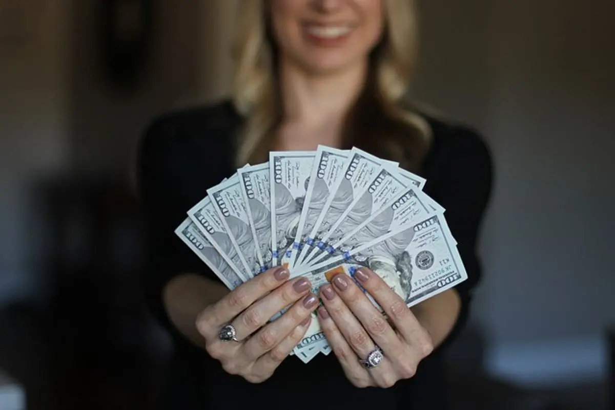 woman-holding-us-100-dollar-bills