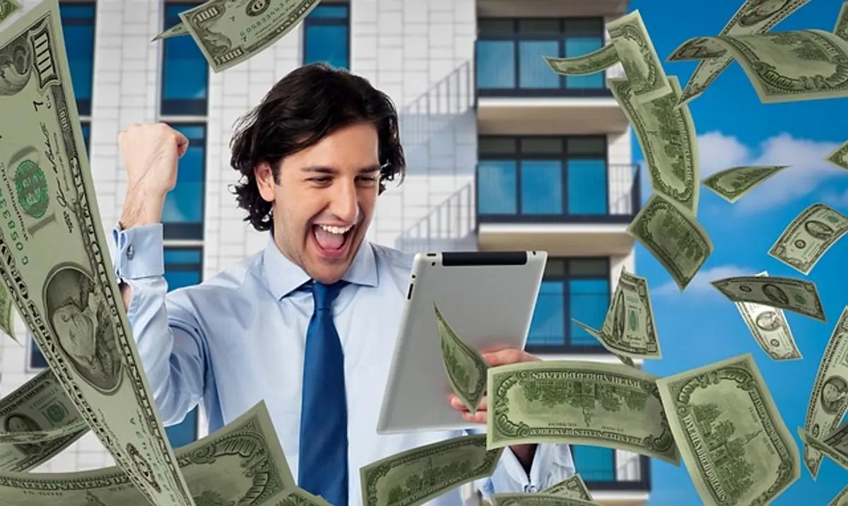 money-faling-from-the-sky-man-holding-tablet