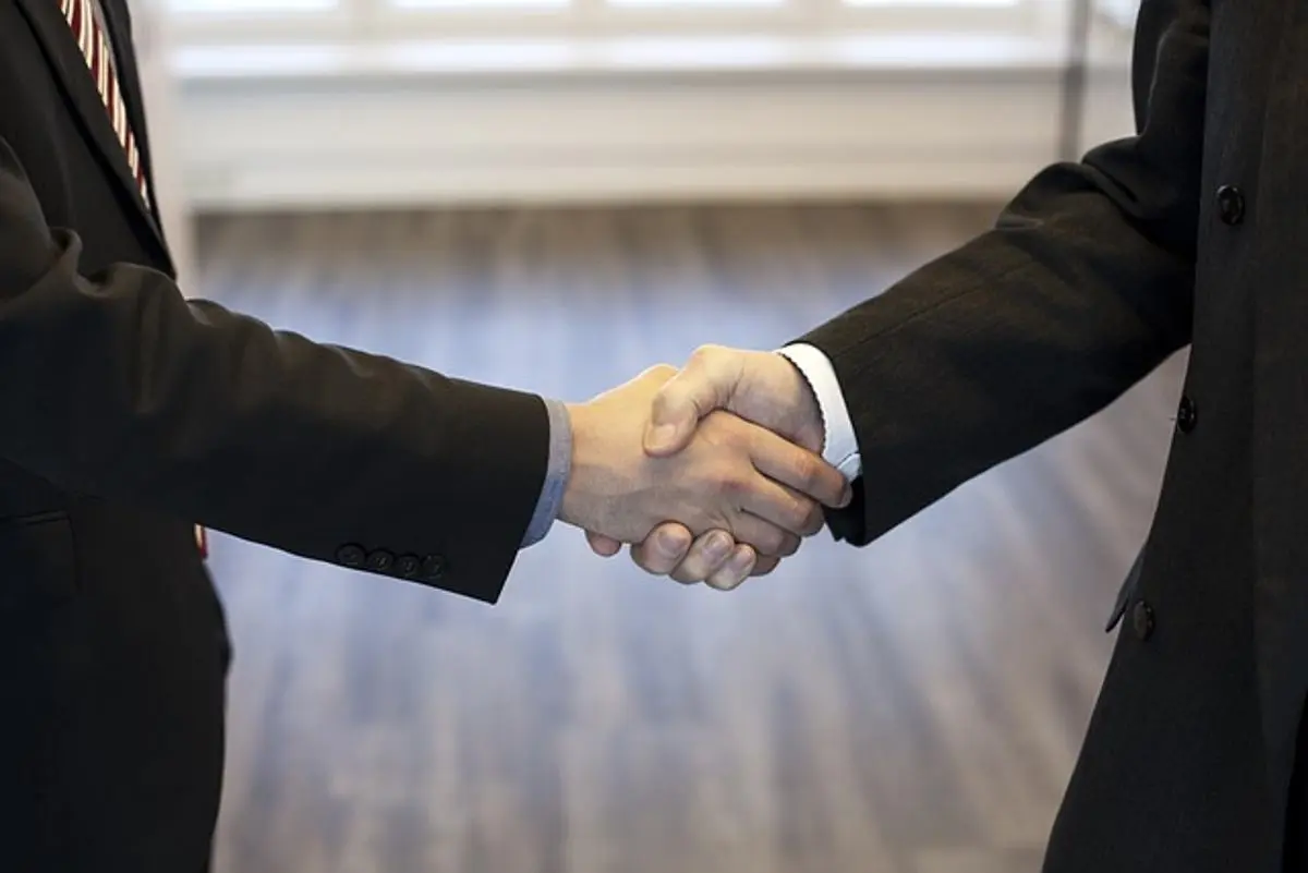 two-businessmen-shake-hands