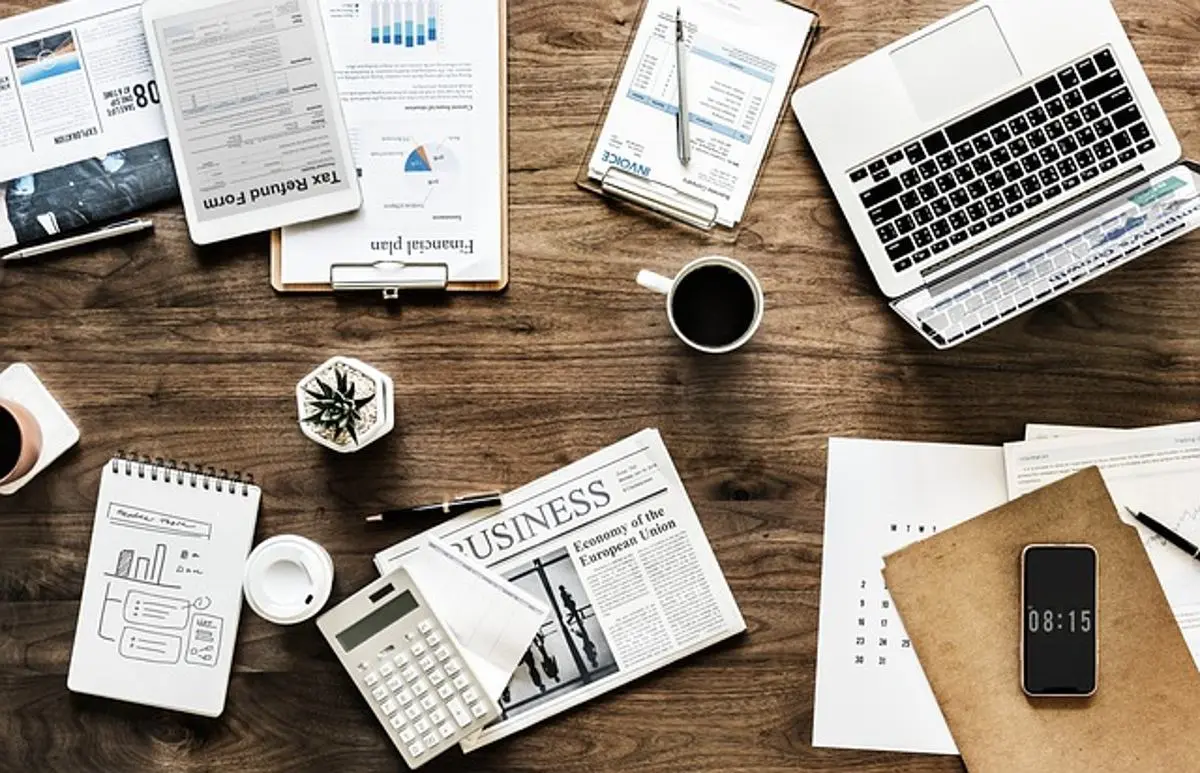 business-desk-with-laptops-notepads-calculator