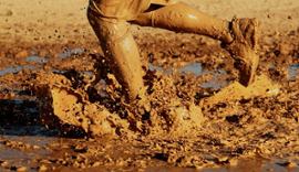 person-running-through-mud