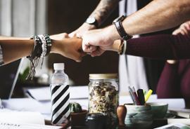 team-members-bumping-fists-collaboration