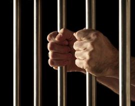 jail-person-holding-bars