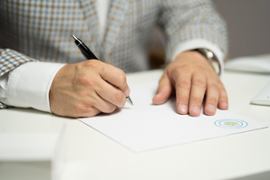 person-signing-a-document