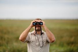 person-looking-through-binoculars