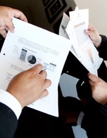 businessmen-looking-at-financial-papers