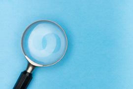 magnifying glass looking at blue background