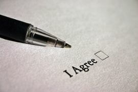 pen-pointing-to-i-agree-box-on-paper