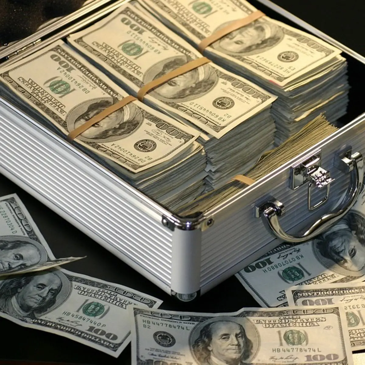 money-100-us-dollar-bills-in-suitcase