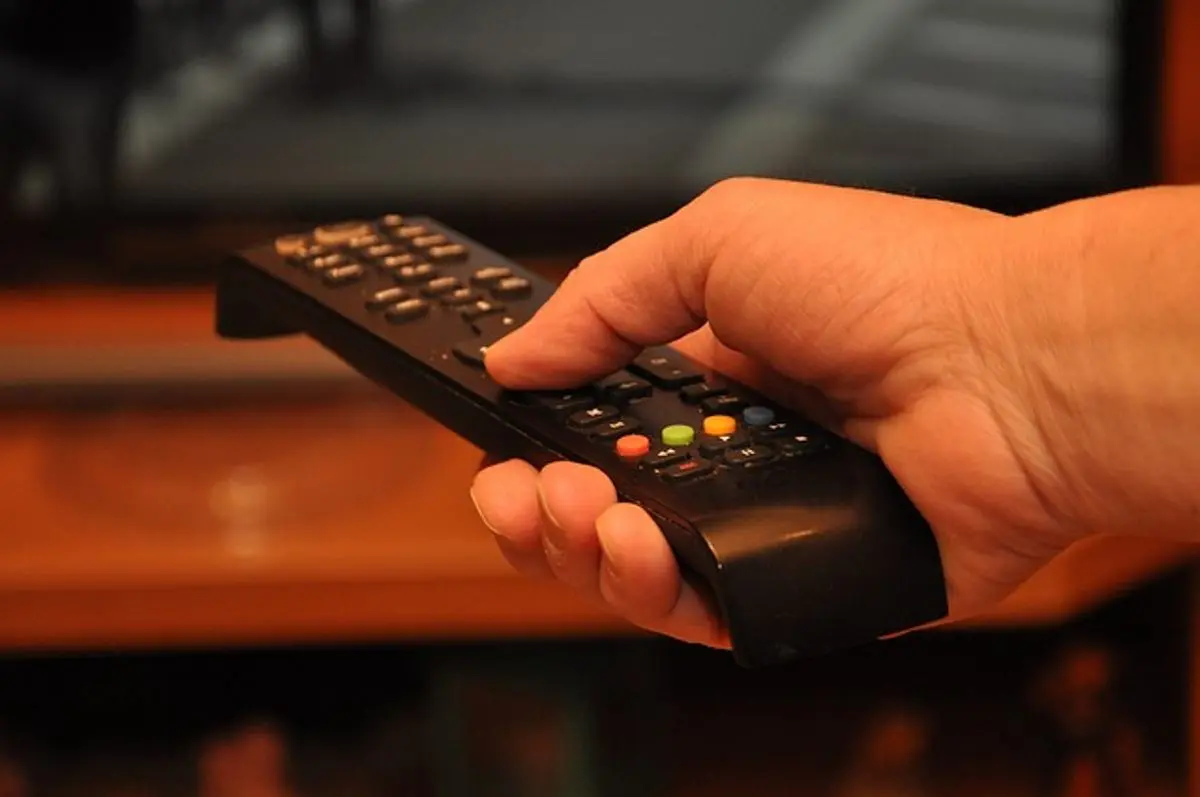 person-holding-tv-remote