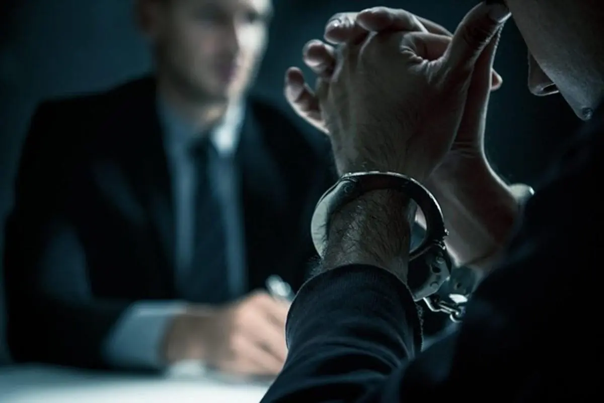 person-with-handcuffs-being-questioned