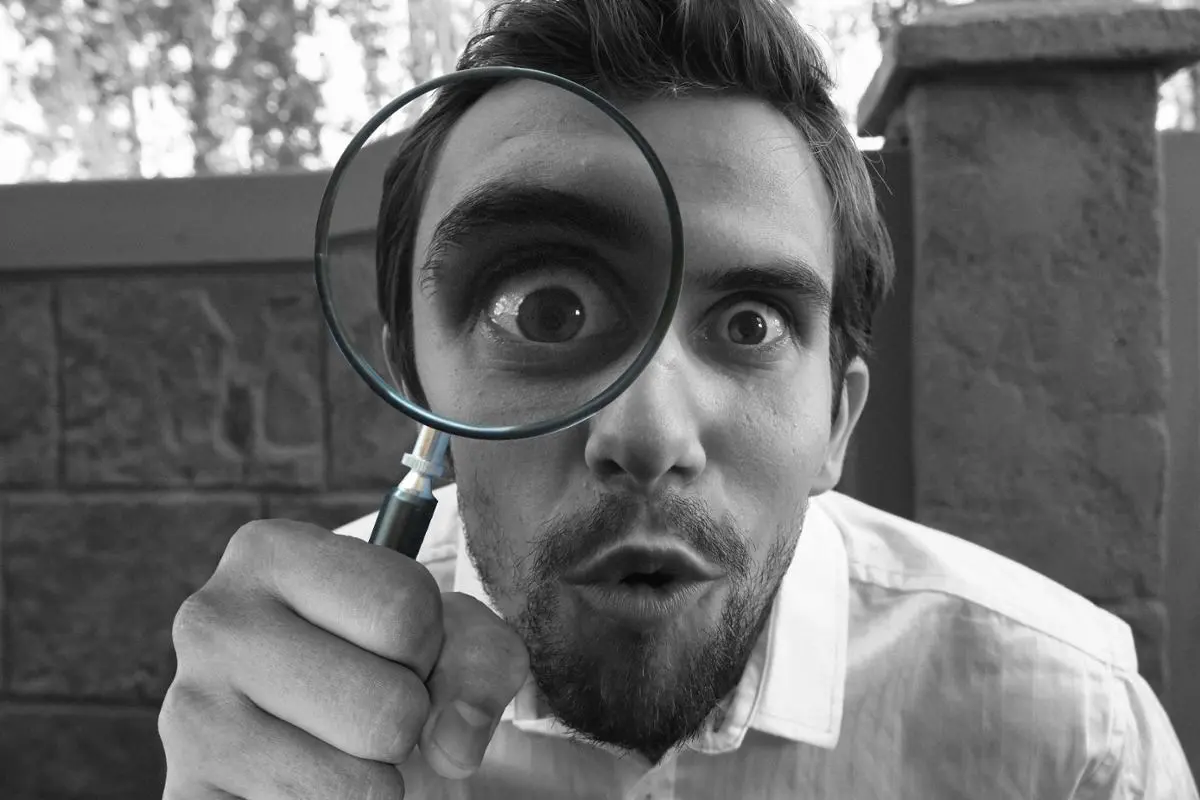 man-looking-closely-with-magnifying-glass