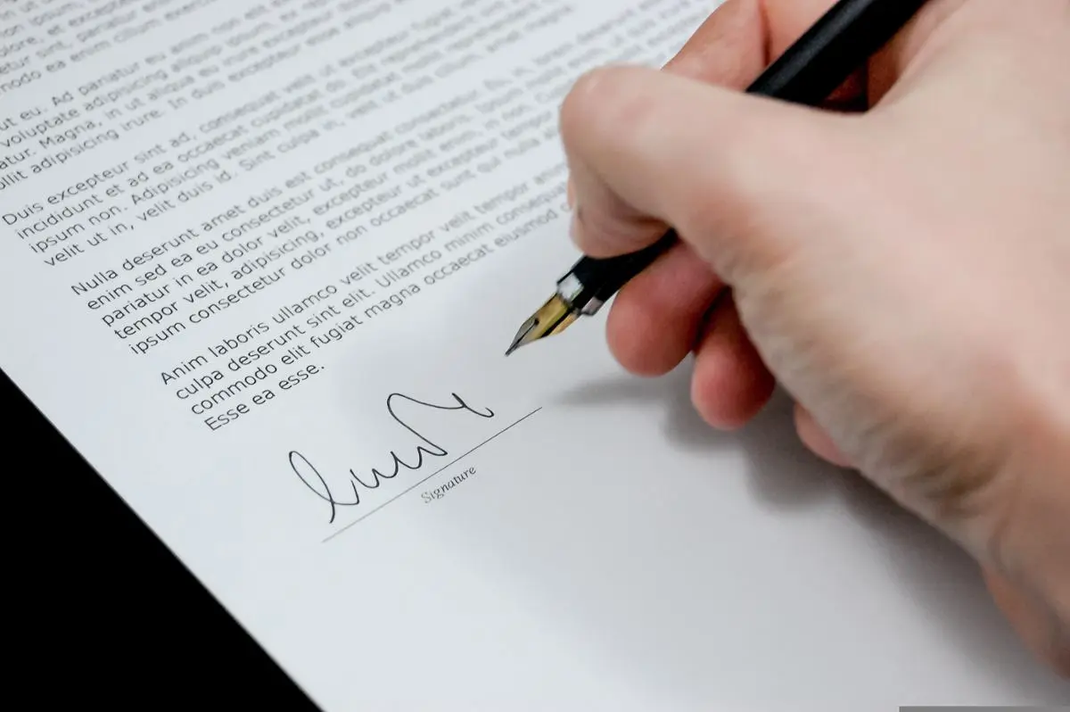 person-signing-document