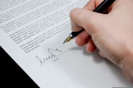 person-signing-document