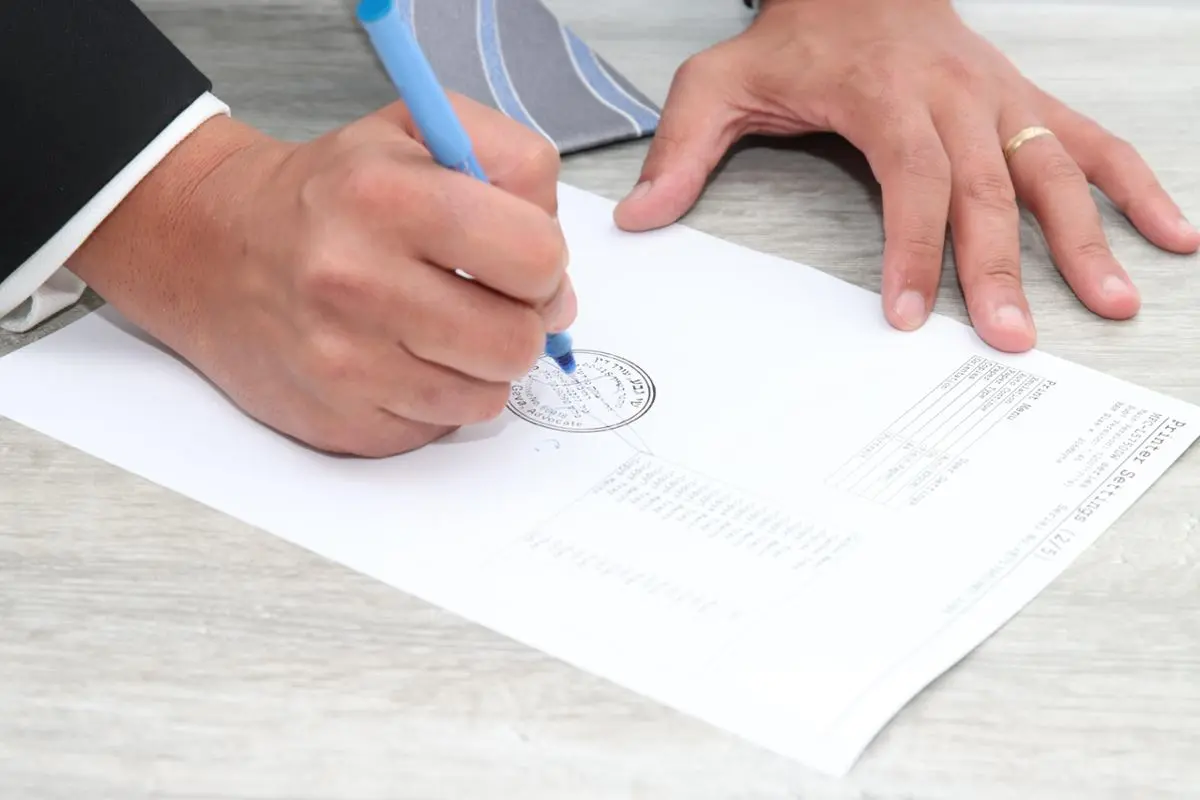 person-signing-a-document