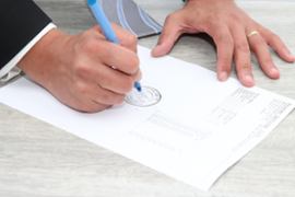 person-signing-a-document