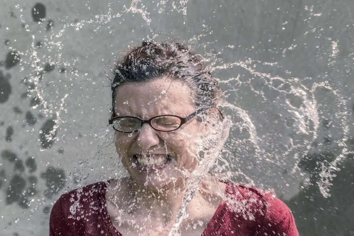 woman-splashed-with-cold-water-in-face
