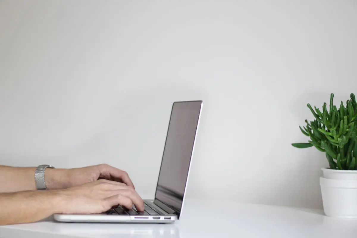 person-writing-on-a-laptop