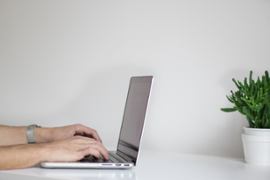 person-writing-on-a-laptop