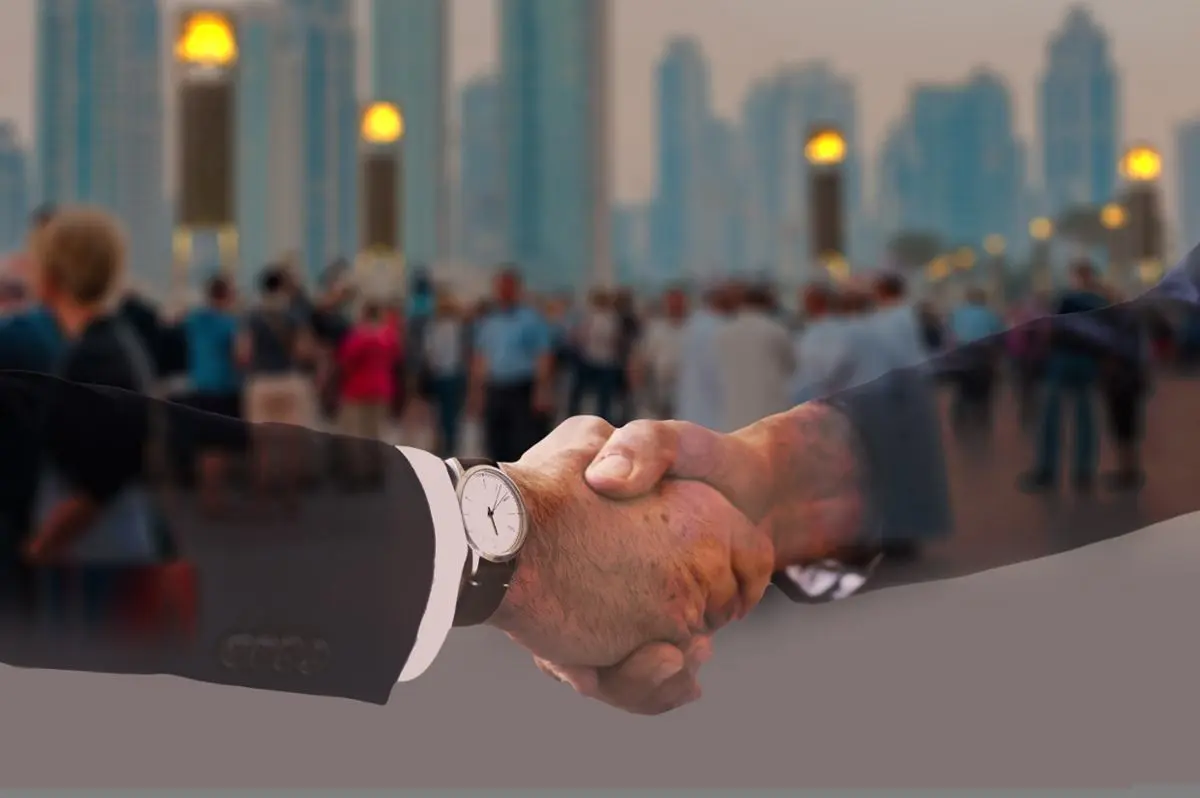 business-team-handshake-cityscape-background