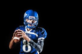 american-football-player-holding-ball