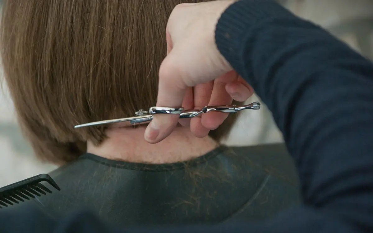 woman-hairdresser-holding-scissors