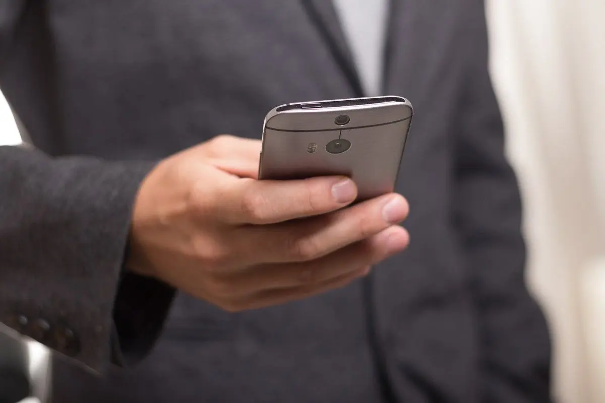 man-in-suit-holding-a-smartphone