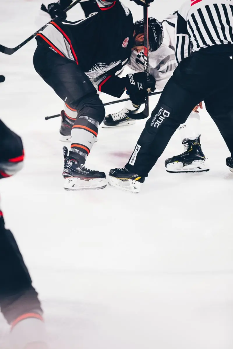 Hockey players and a referee clashing. 