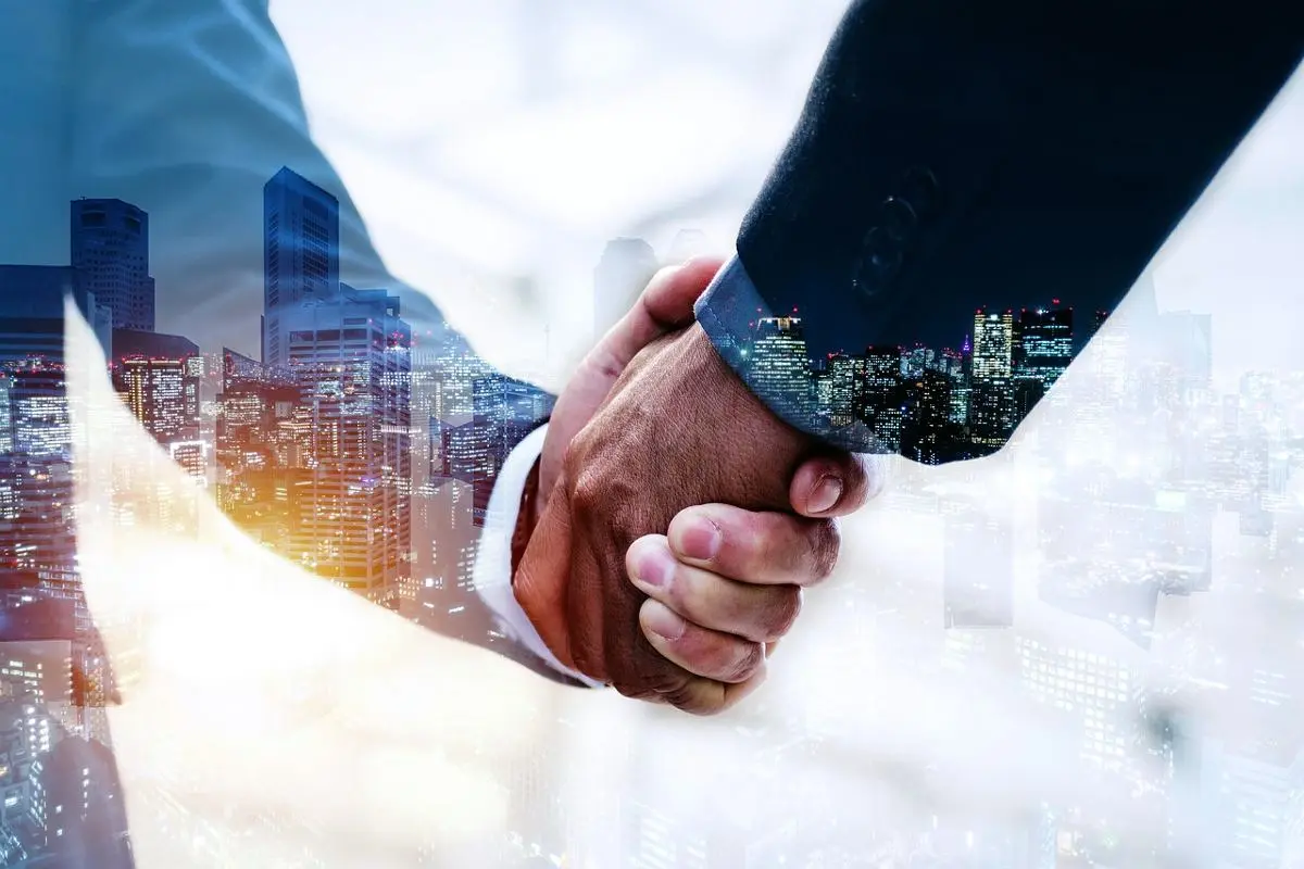 two-hands-in-a-handshake-with-cityscape-background