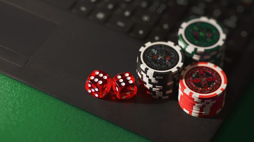 poker-chips-and-dice-on-top-of-laptop