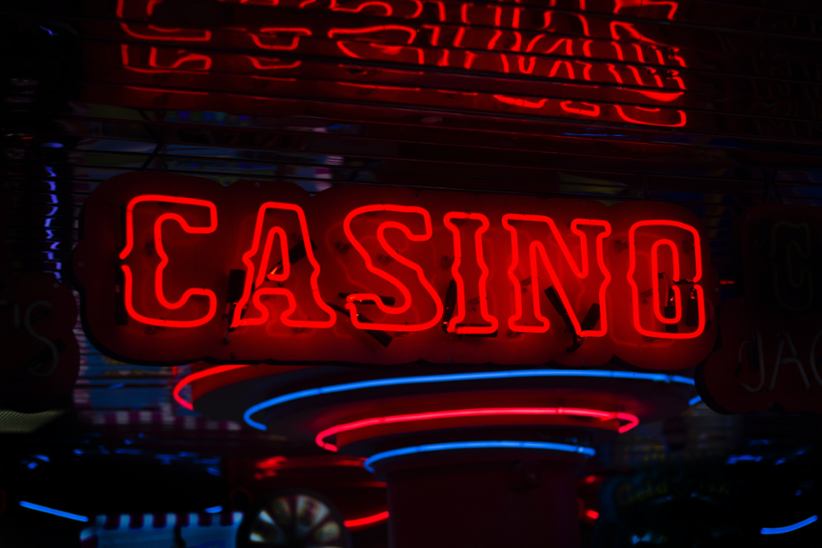 A neon red-lit sign that says casino.
