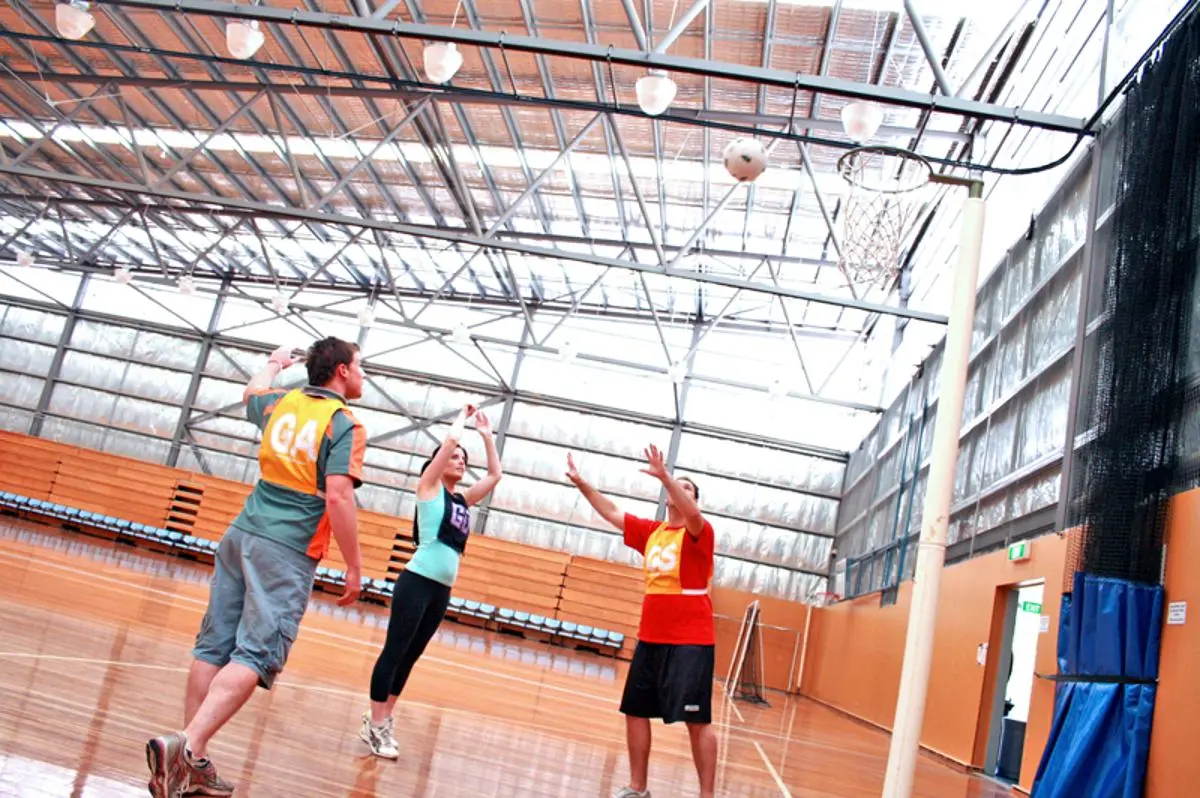 A netball court with players.