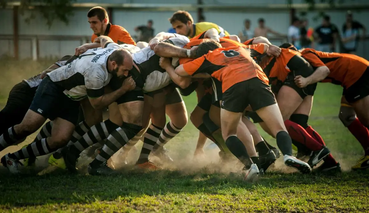 Rugby players scrambling for the ball.