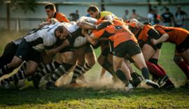 Rugby players scrambling for the ball.