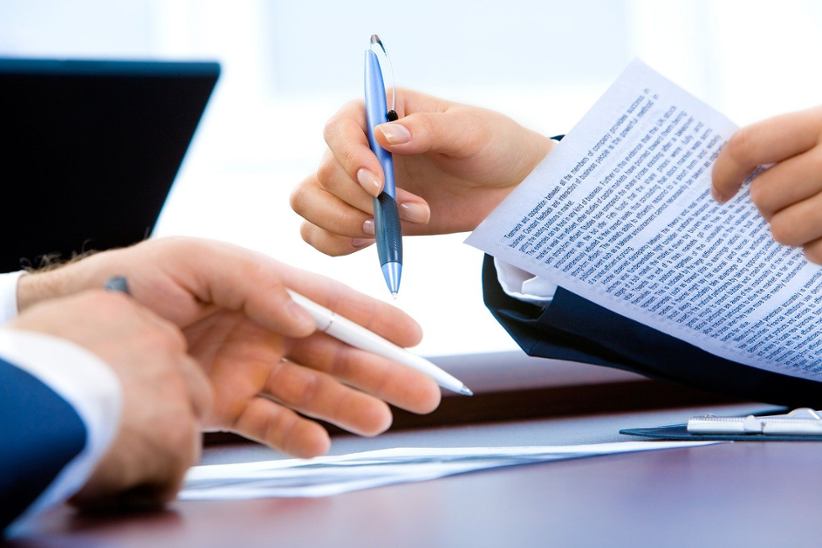 businessman-and-woman-signing-documents