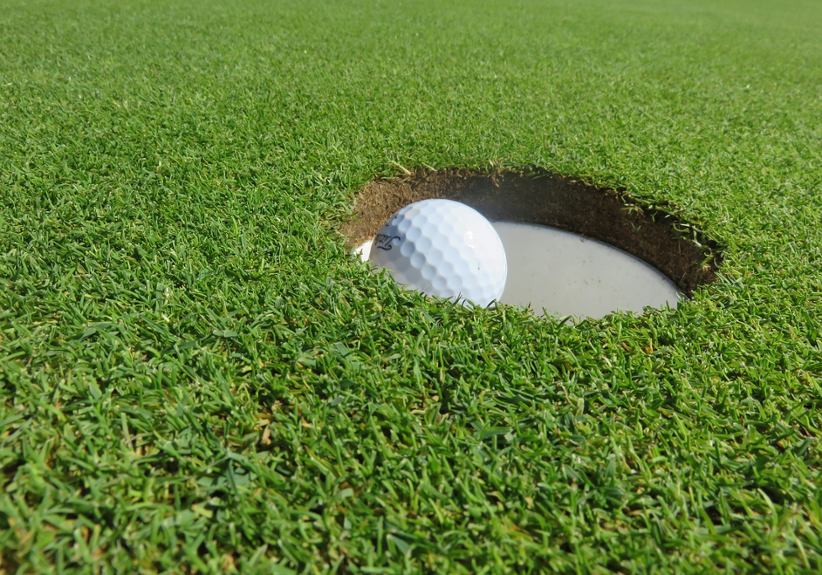 golf-ball-falling-in-hole