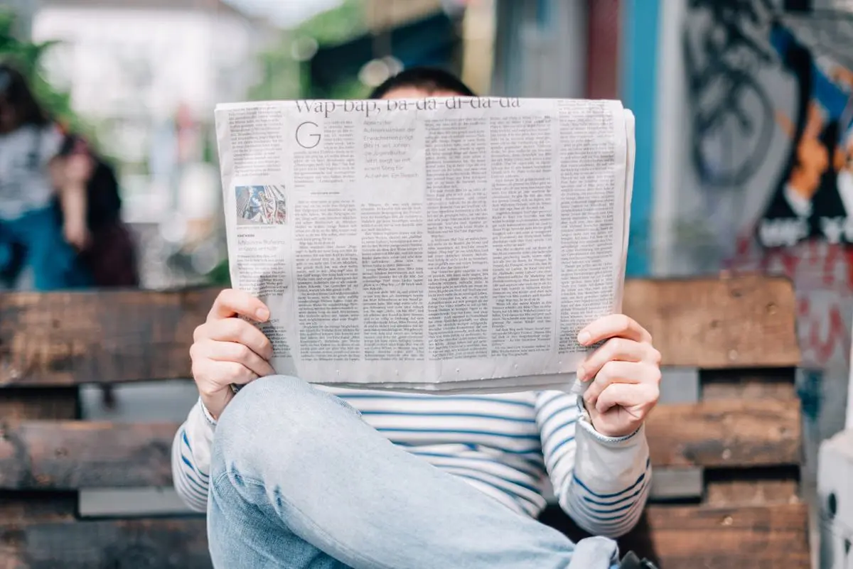 A man reading a newspaper.