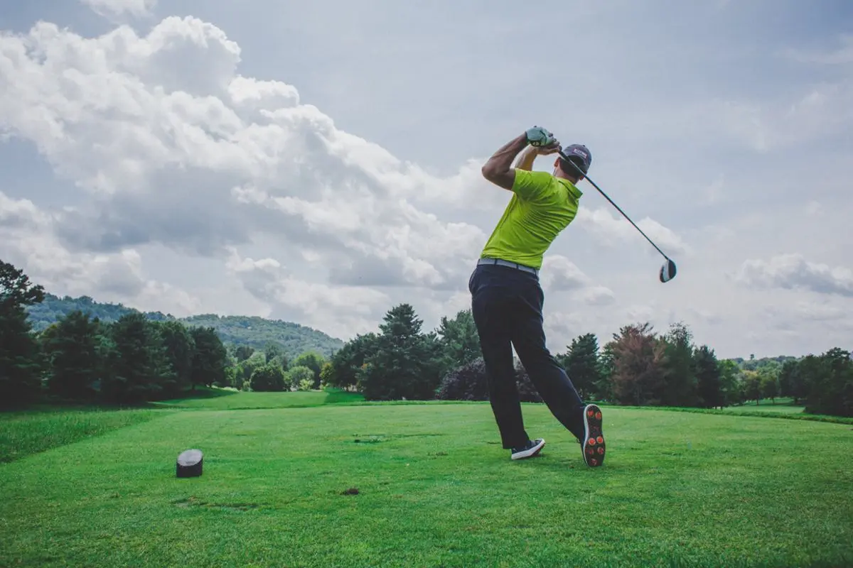 A man taking a swing at golf. 