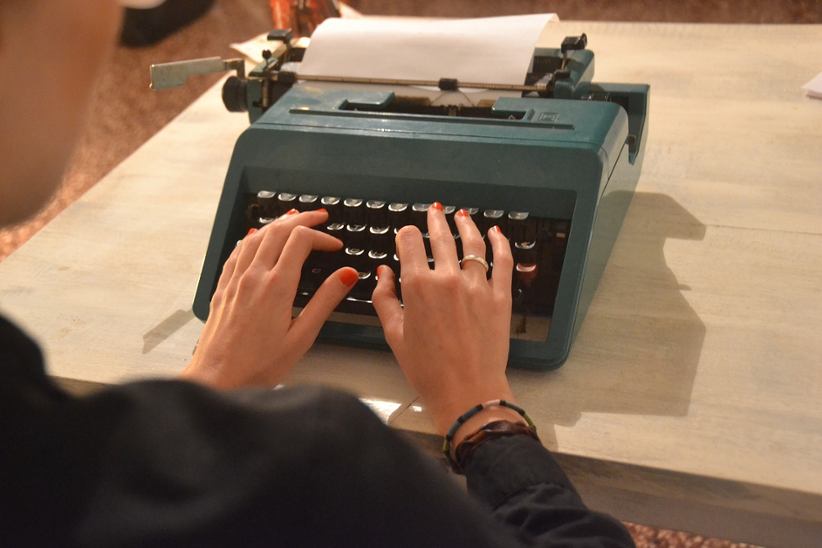 woman-typing-on-typewriter