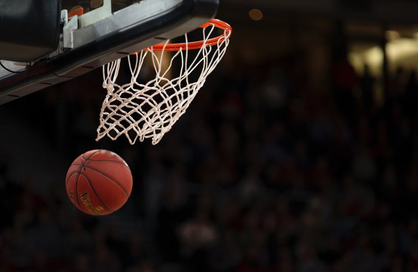 A basketball being shot in the basket.