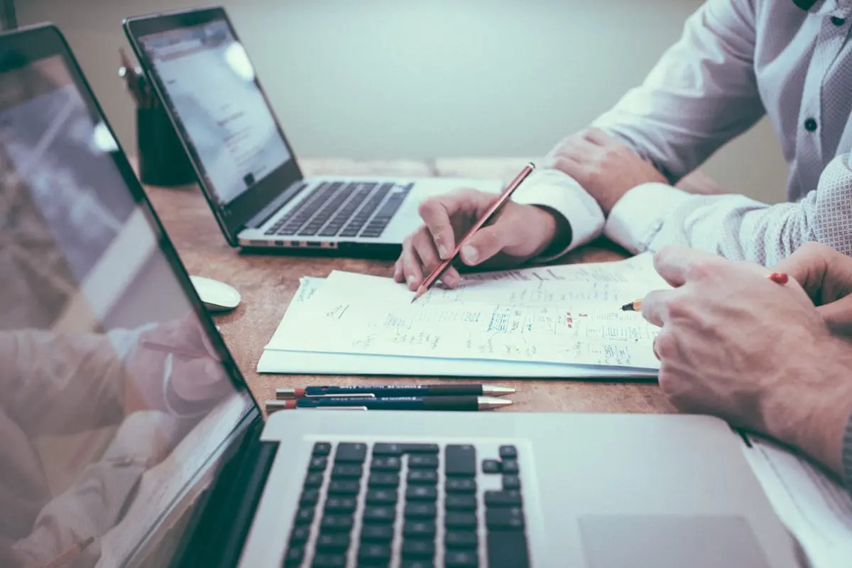 business-men-with-laptops-draw-on-sheet-of-paper