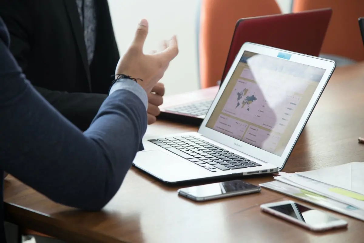 two-businessmen-talking-in-front-of-laptops