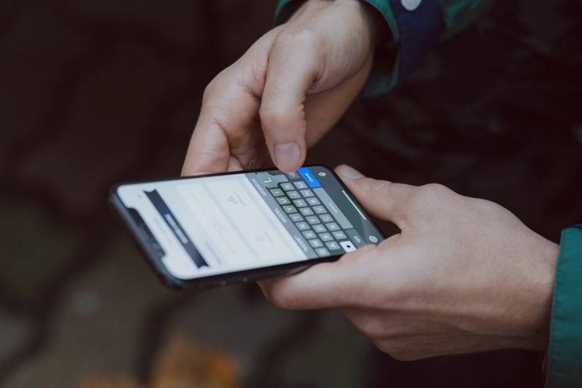 A person checking or typing a message on a phone.