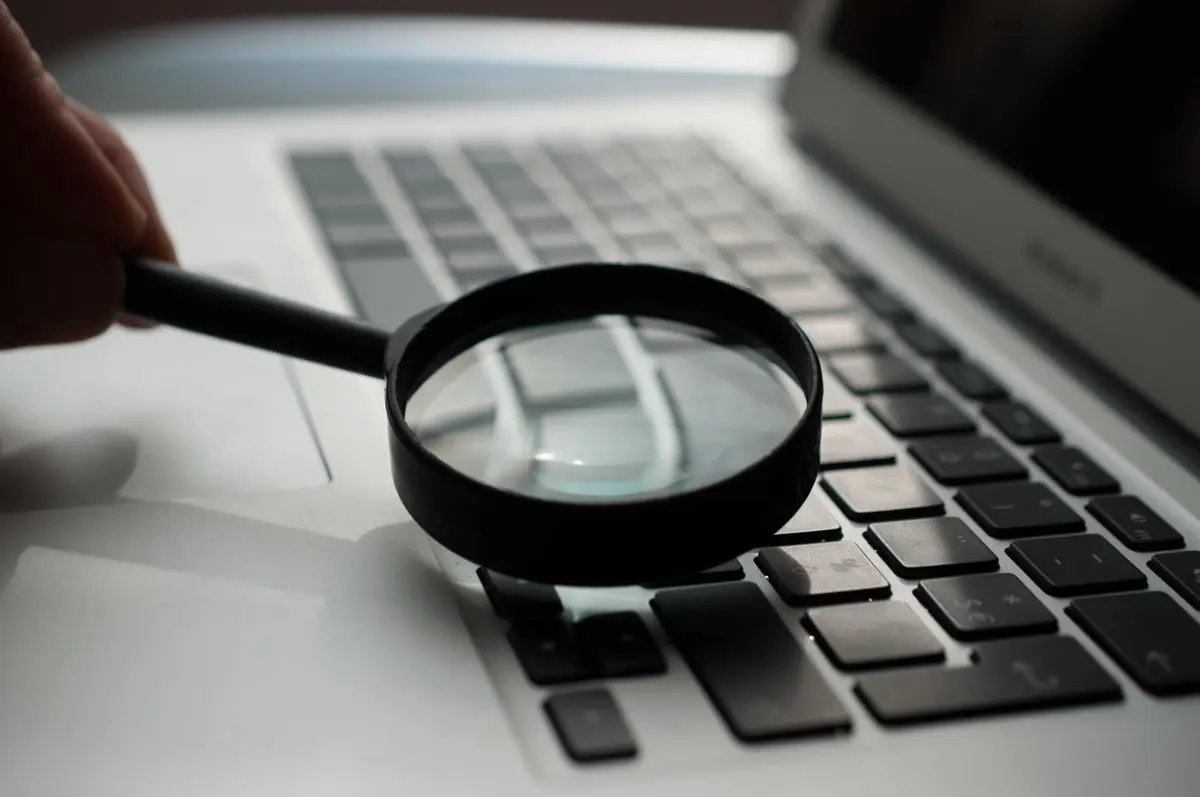 A magnifying glass placed over a keyboard.