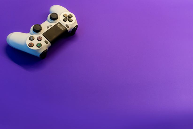 A joystick for console against a purple background.