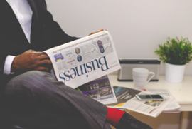 A man reading a newspaper.