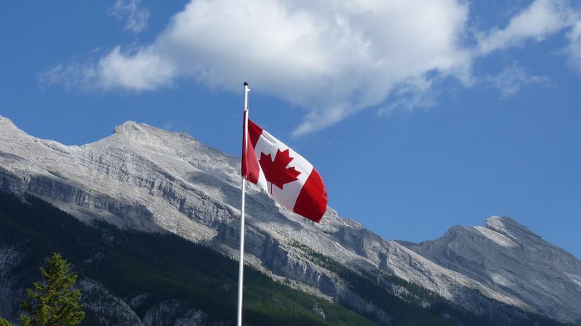 canada-flag-on-a-pole-mountain-in-background